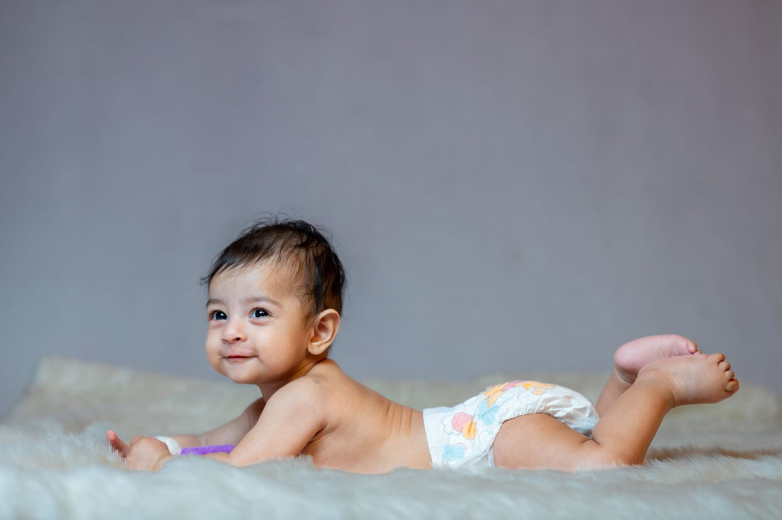 Bébé souriant en couche sur couverture douce